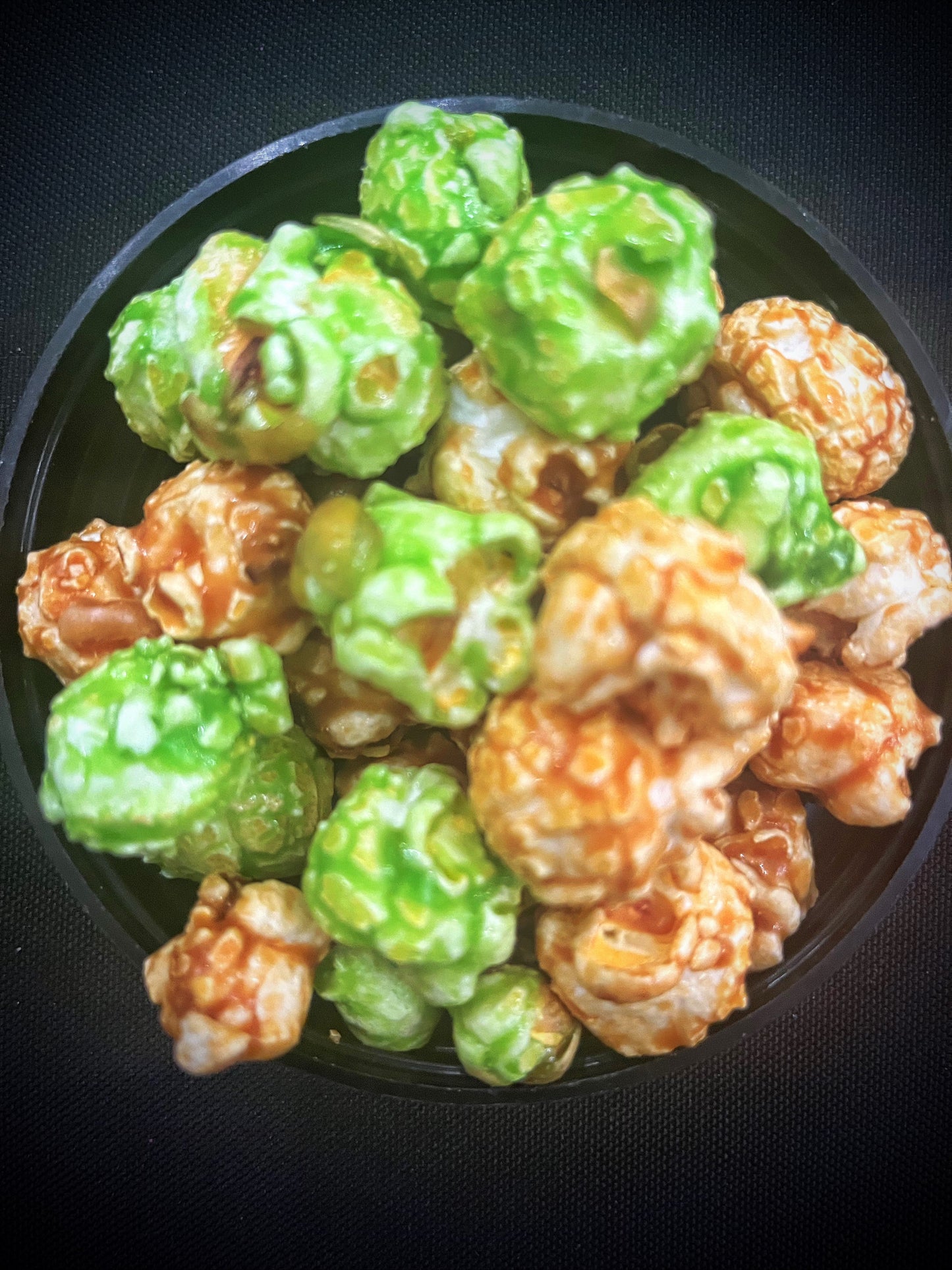 Caramel and green apple popcorn mix in a bowl.