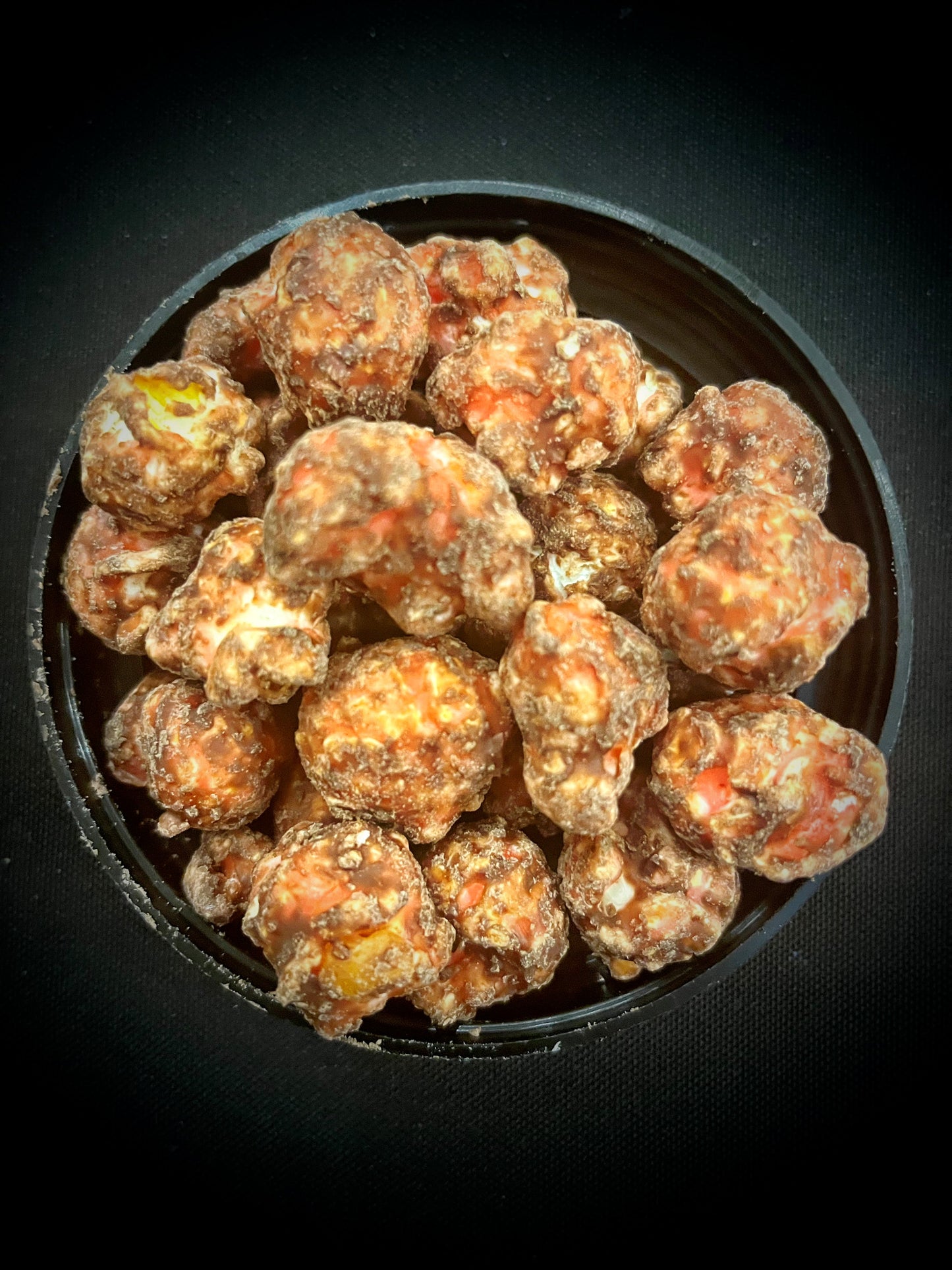 Raspberry truffle popcorn covered in rich raspberry chocolate.