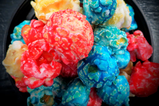 Colorful Bomb Pop flavored popcorn in red, white, and blue.