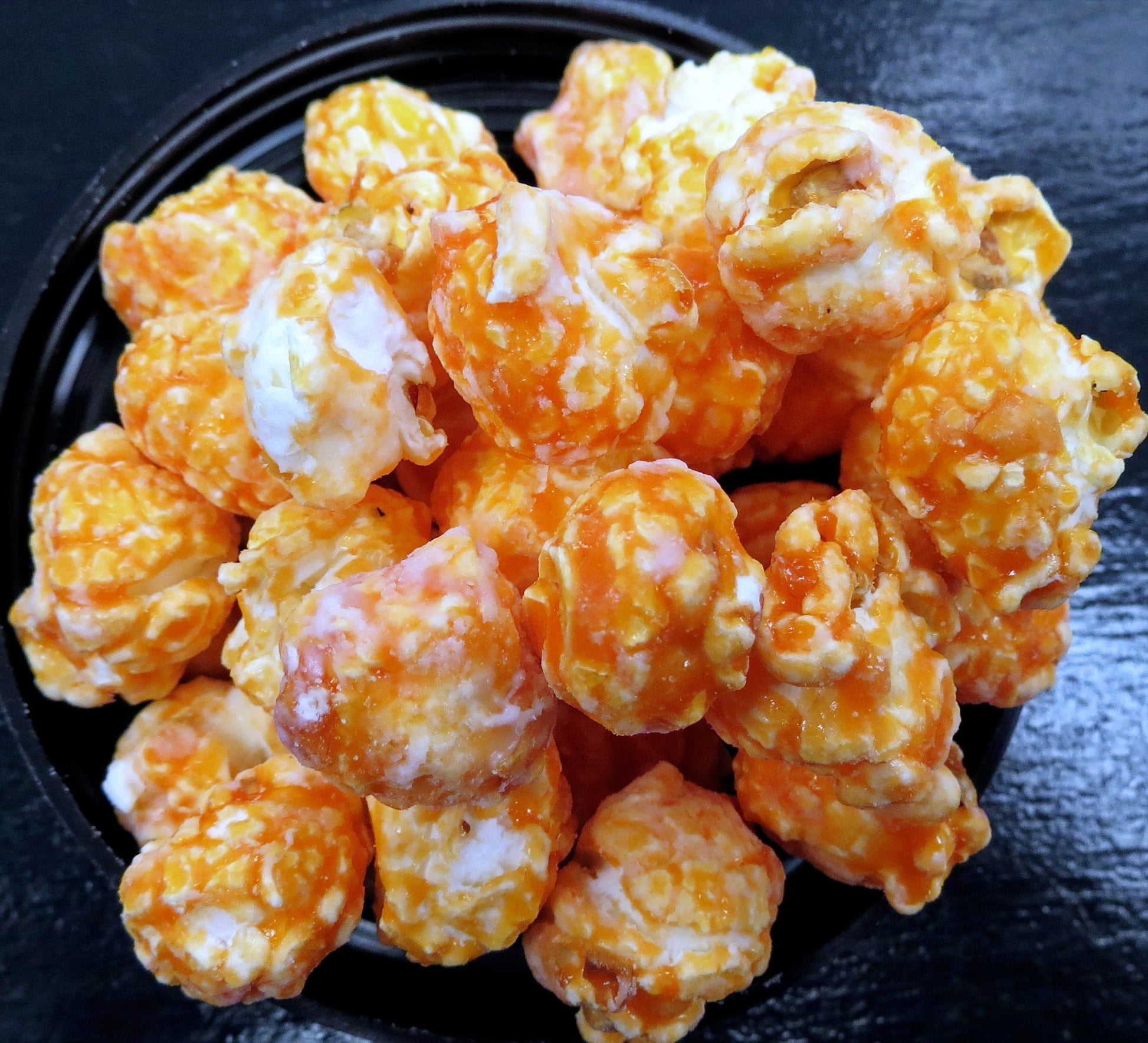 Dr. Pop flavored popcorn in a bowl, featuring caramel and cheese coatings.