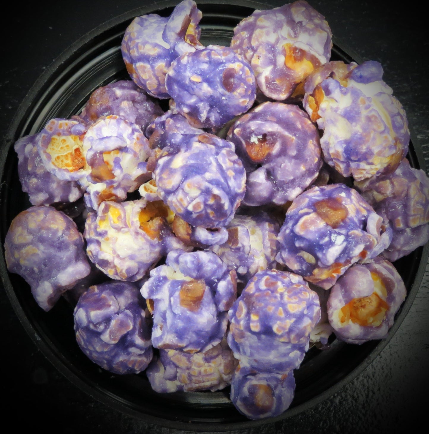 Huckleberry flavored popcorn with vibrant purple coating.
