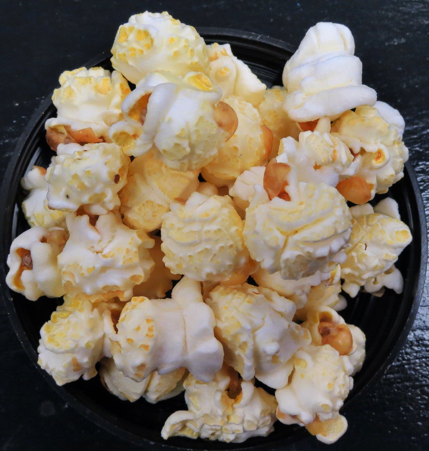 Bowl of guacamole-flavored popcorn with spicy peppers.