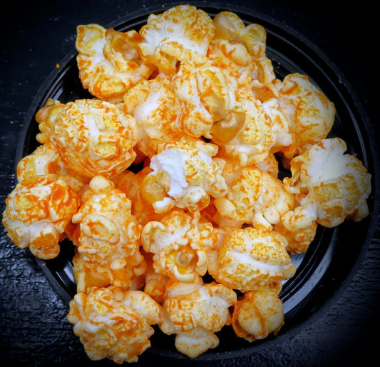 Taco-flavored popcorn with vibrant seasoning in a bowl.