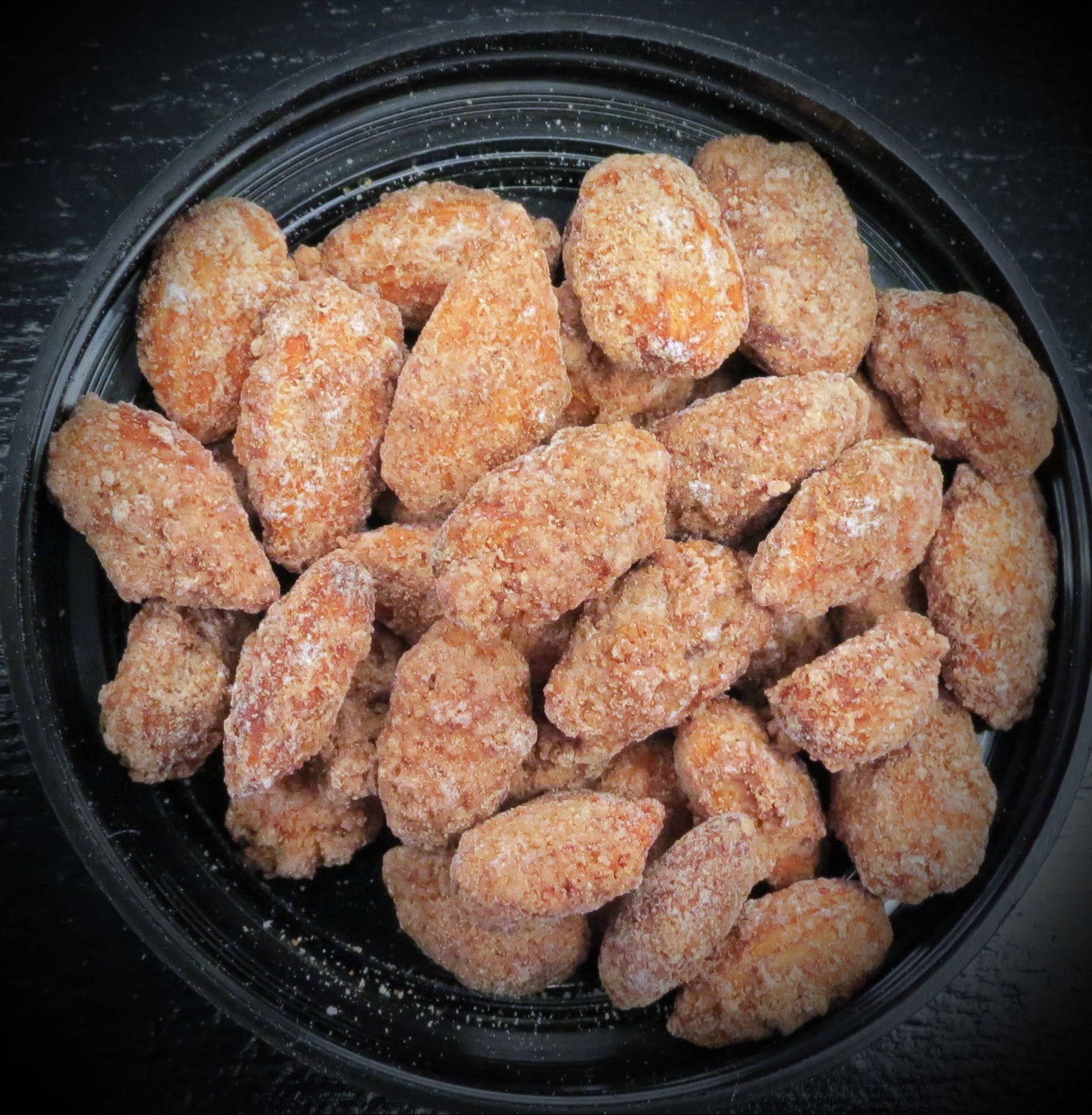 Cinnamon sugar almonds in a black bowl.