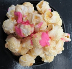 Champagne flavored popcorn drizzled with strawberry chocolate.
