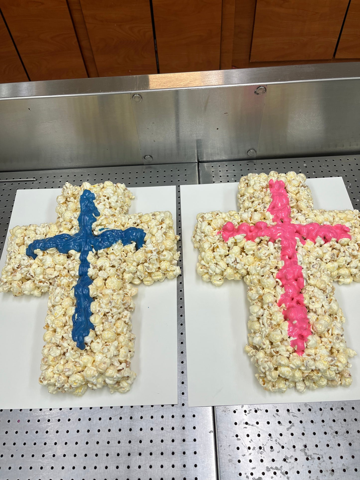 Cross-shaped popcorn ball with decorative colored icing.