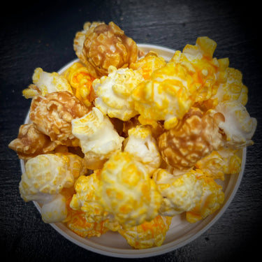 Yellow and White Cheddar caramel popcorn mix in a bowl
