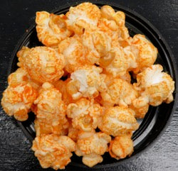 Close-up of Jalapeno Cheddar flavored popcorn with creamy cheddar and pickled jalapeno seasoning